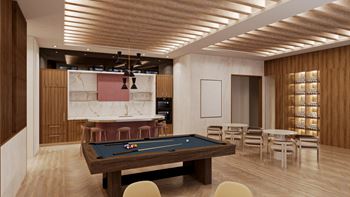 A spacious game room with a pool table and a bar